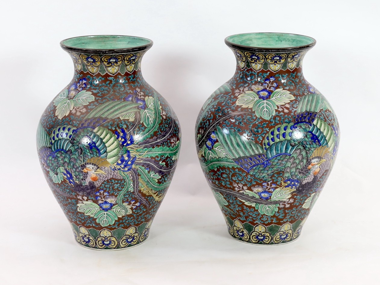 A pair of massive Japanese Kutani porcelain vases, Meiji period, influenced by de Morgan designs, 61.5cm high, one repaired